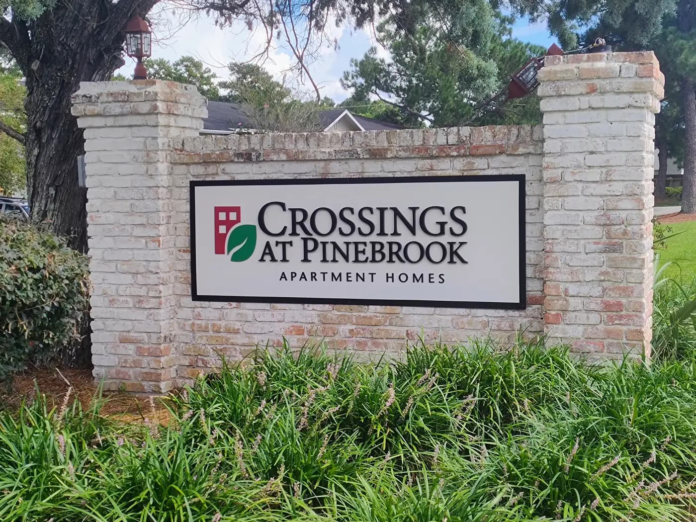 Crossings at Pinebrook Apartment Homes entrance sign on Michael Boulevard
