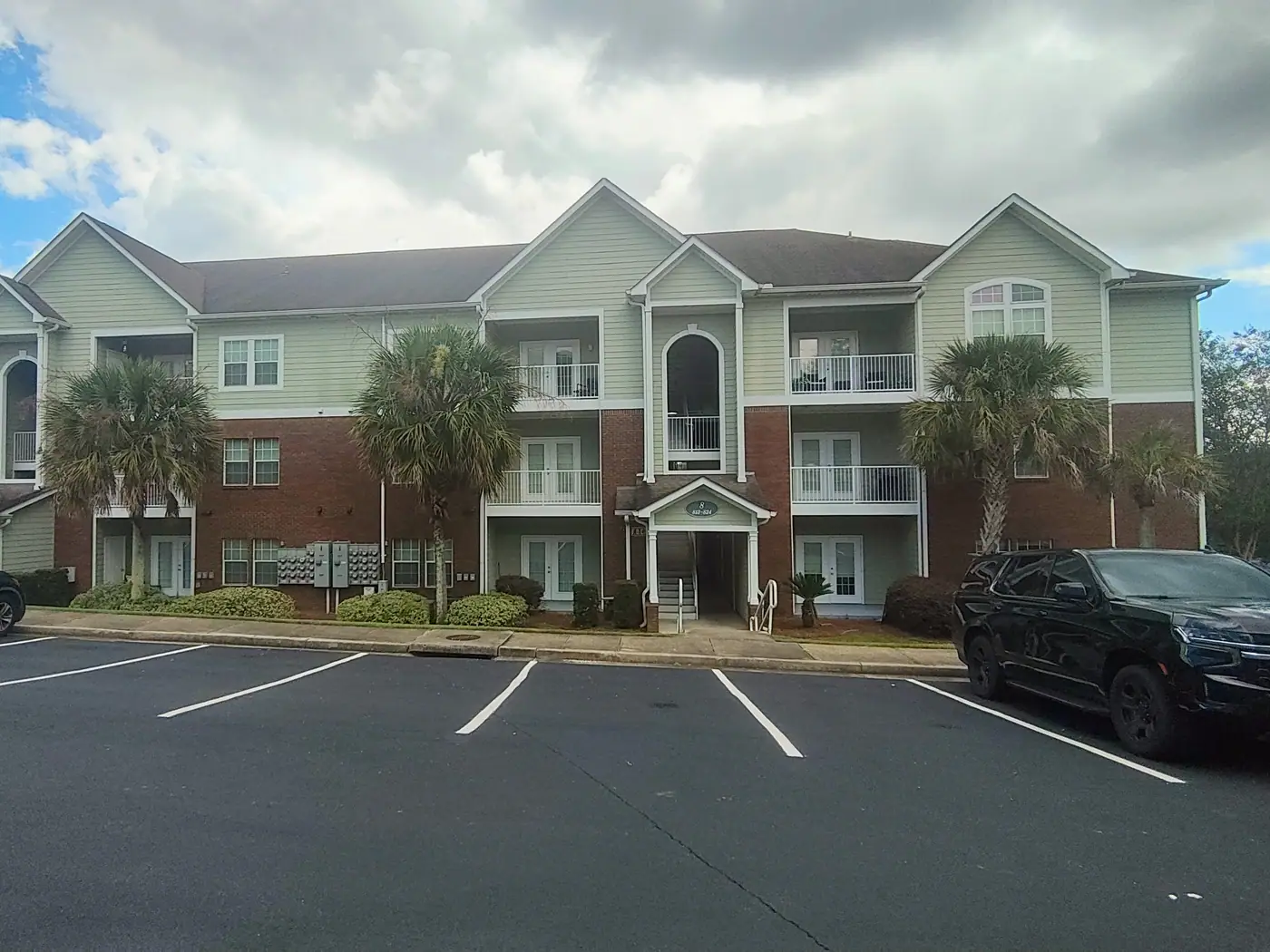 Three-story residences and palms at Cypress Cove