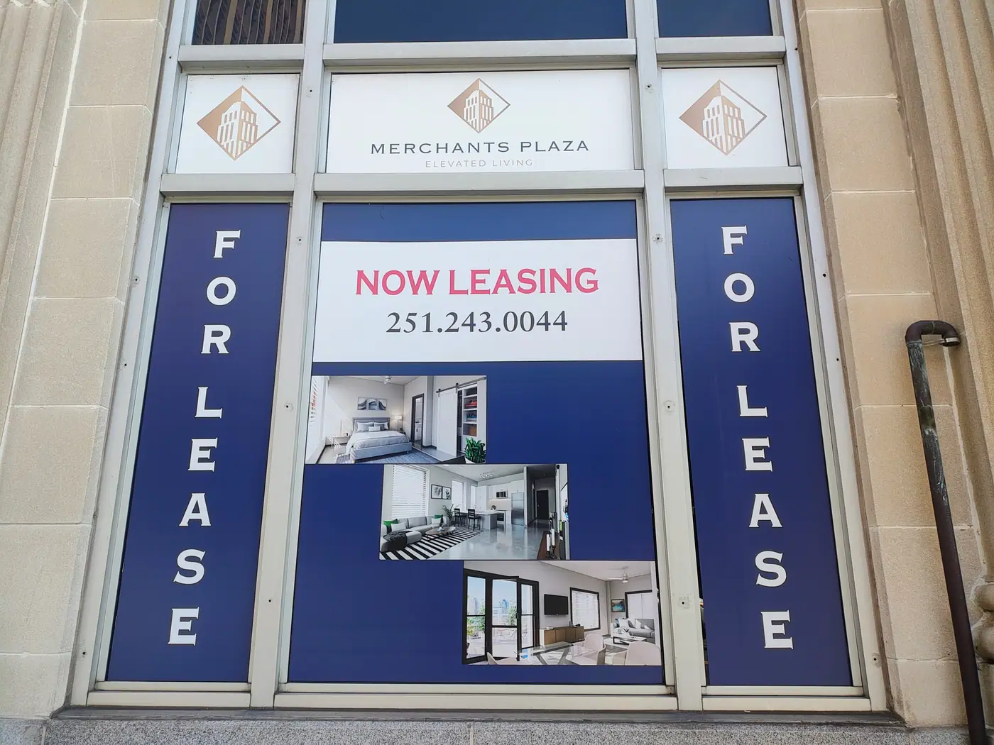 Merchants Plaza leasing signage in a street-level window