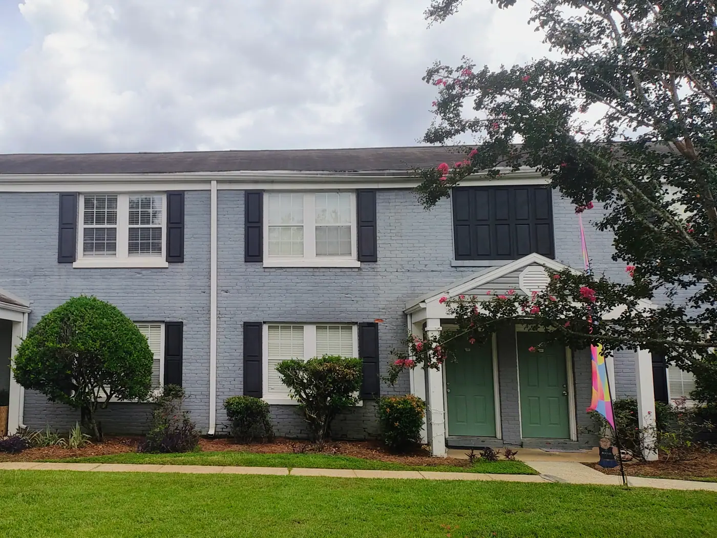 Townhome exterior with shuttered windows at Midtown Oaks